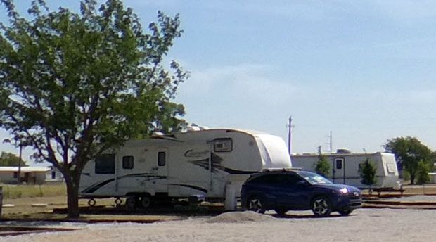 Fifth-wheel RVs parked on long-term sites at Stoney Acres RV Park in Ponder, TX